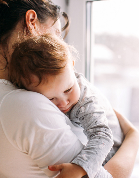 baby sleeping on mothers shoulder