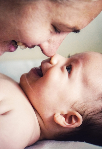 baby smiling at mom