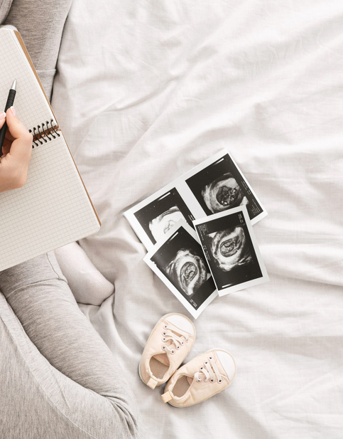 Pregnant woman with ultrasound photos