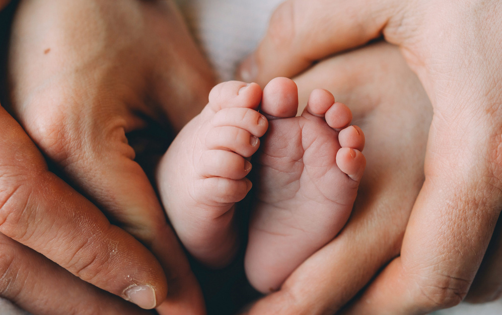 dad holding baby feet